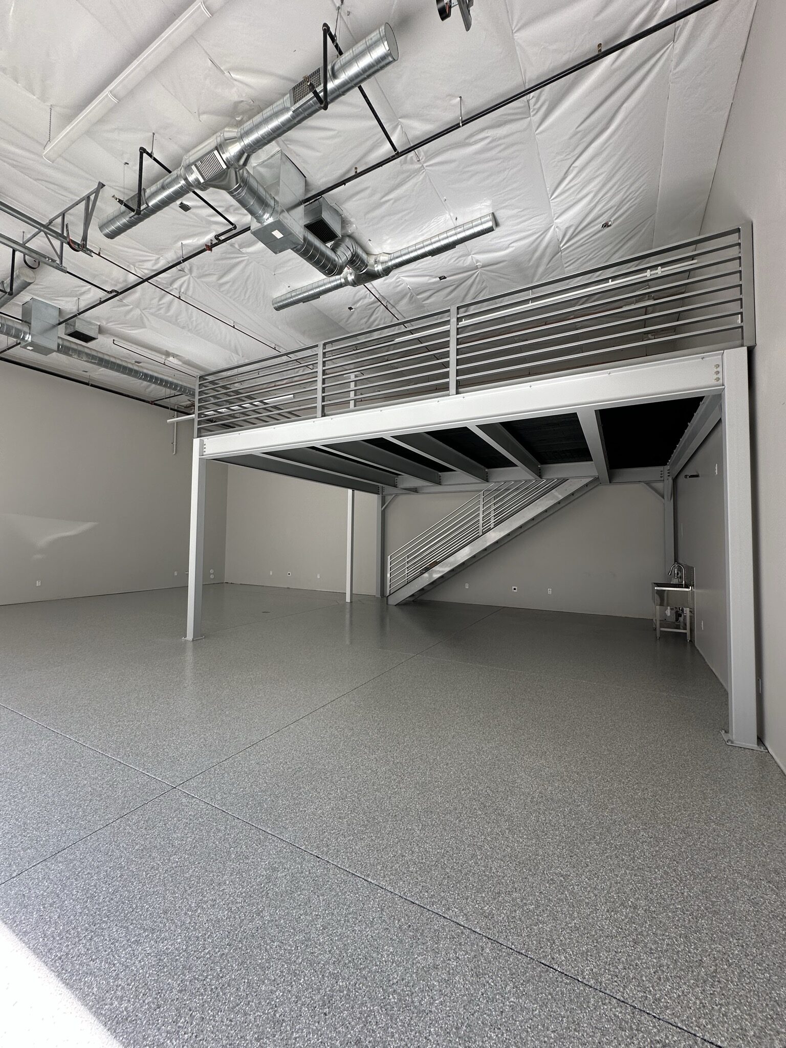 Gray Blue Flake commercial floor coating with mezzanine in Fountain Hills AZ by RX Garage