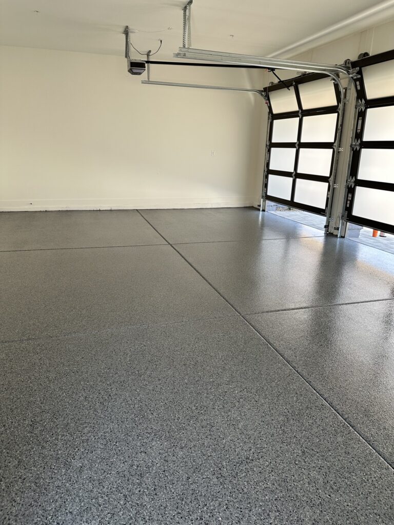 Gray Flake garage floor coating with glass doors in Scottsdale AZ by RX Garage
