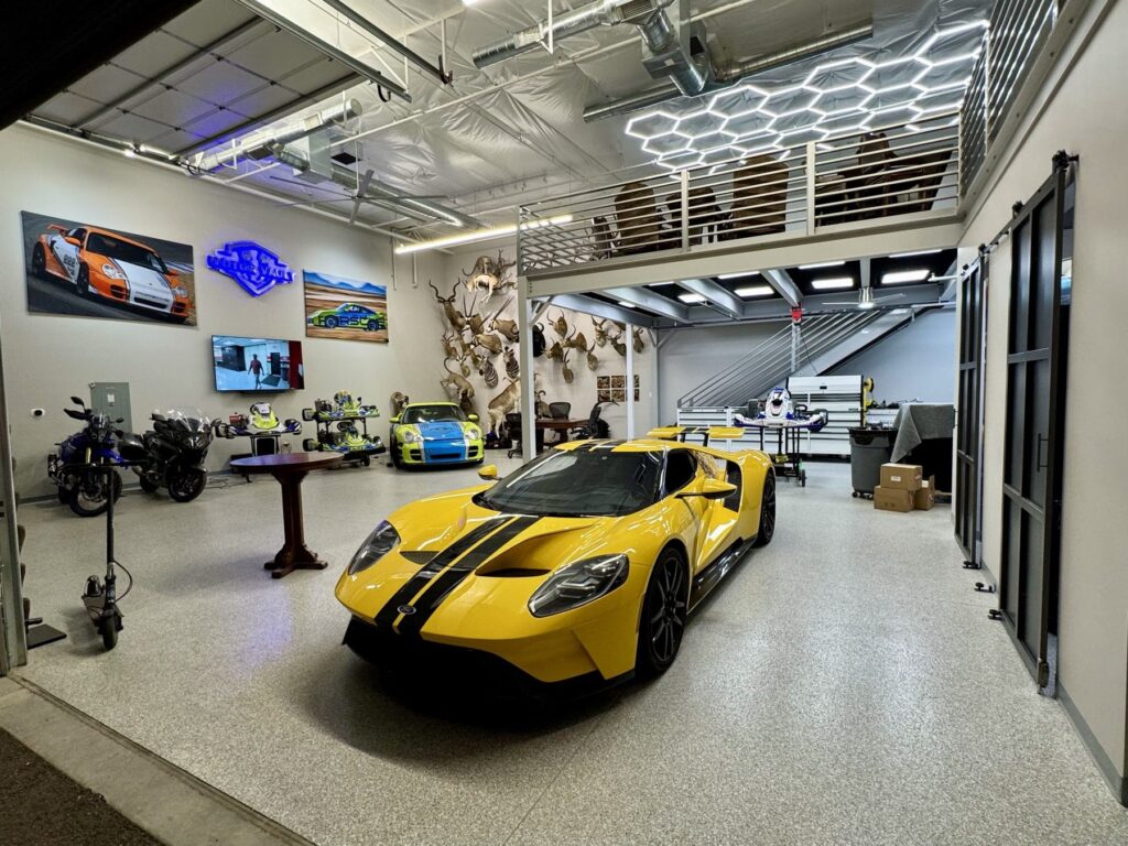 Motor Vault Fountain Hills luxury garage suite with gray polyaspartic flake floor, yellow Ford GT and Porsche 911, installed by RX Garage LLC